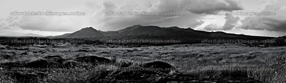 Kumamoto volcanic meadow with dark rocks and distant mountains – stock images 14762x4268