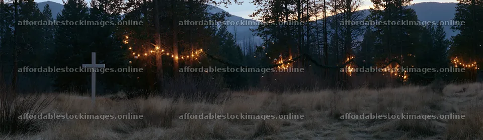 White Christian cross in remote meadow at dusk – stock images 14762x4268