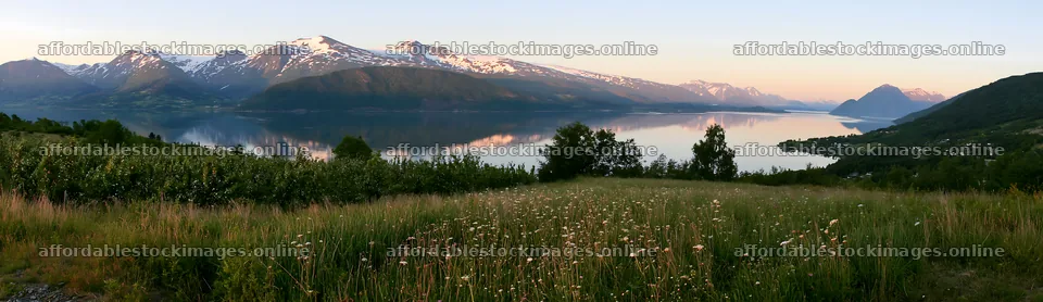 Fjord orchard meadow with mountains and water reflection – stock images 14762x4268
