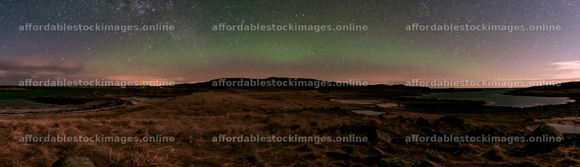 Aurora lights over a meadow by the coast at night – stock images 14762x4268