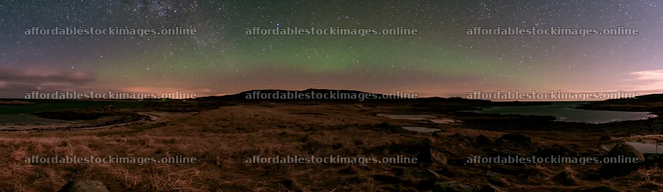 Aurora lights over a meadow by the coast at night – stock images 14762x4268