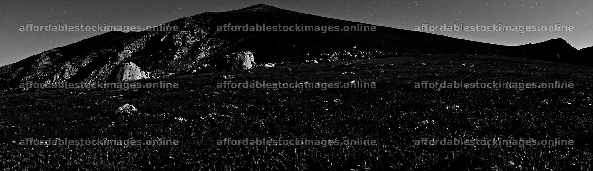 Night blooming meadow under a mountain silhouette – stock images 14762x4268
