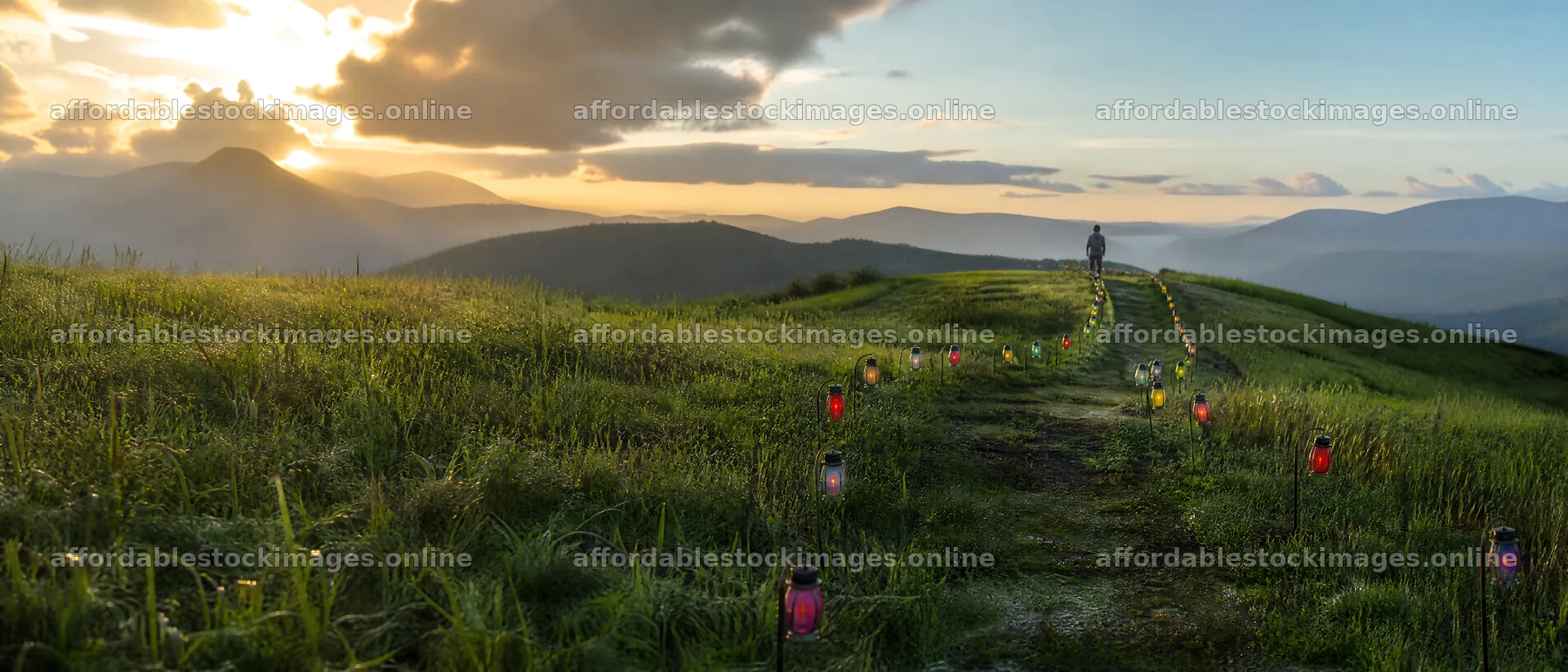 Colorful lanterns along a path in a meadow at sunset – stock images 12124x5196