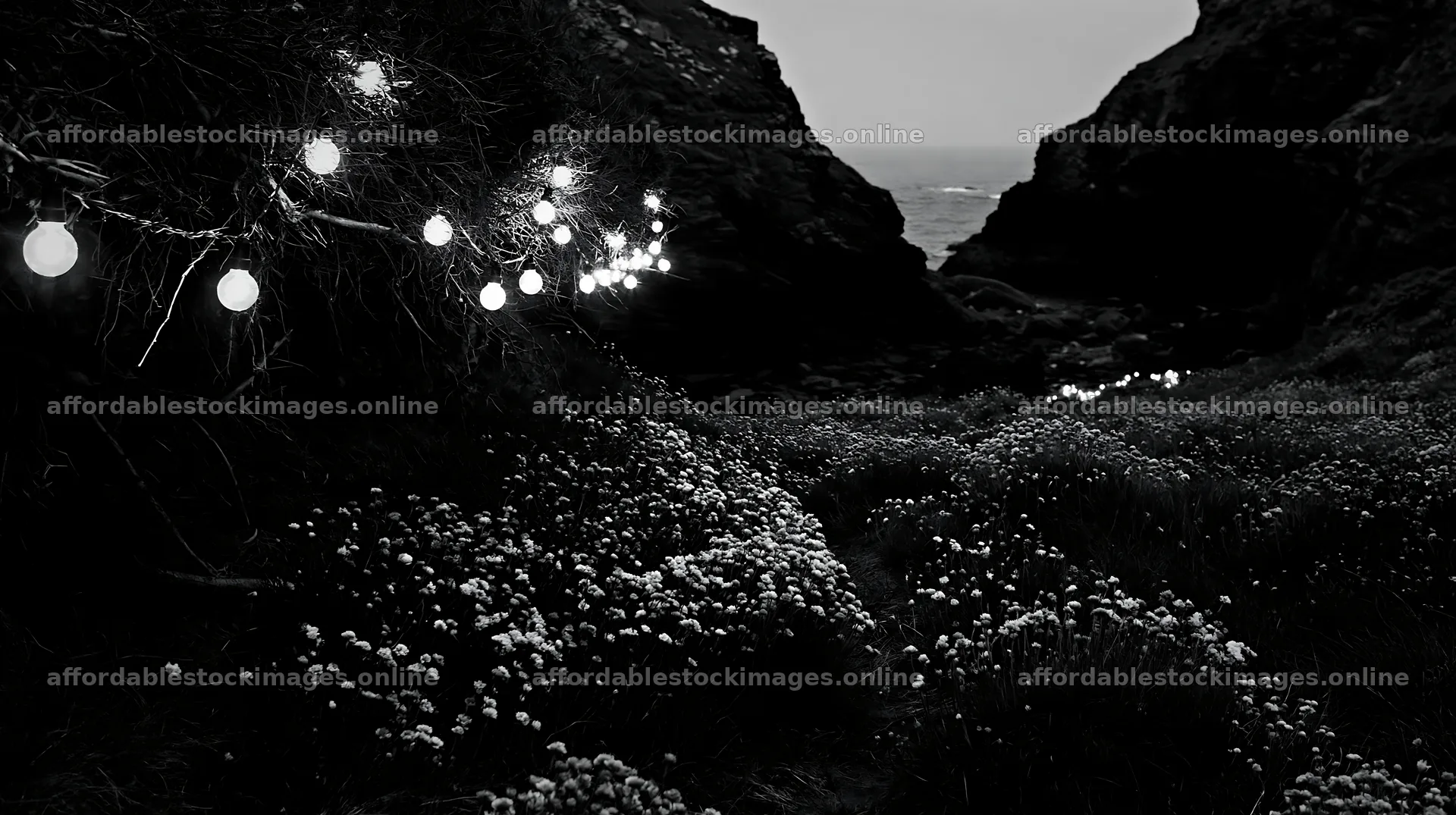 Christmas lights at dusk in a meadow near a cave – stock images 10608x5938