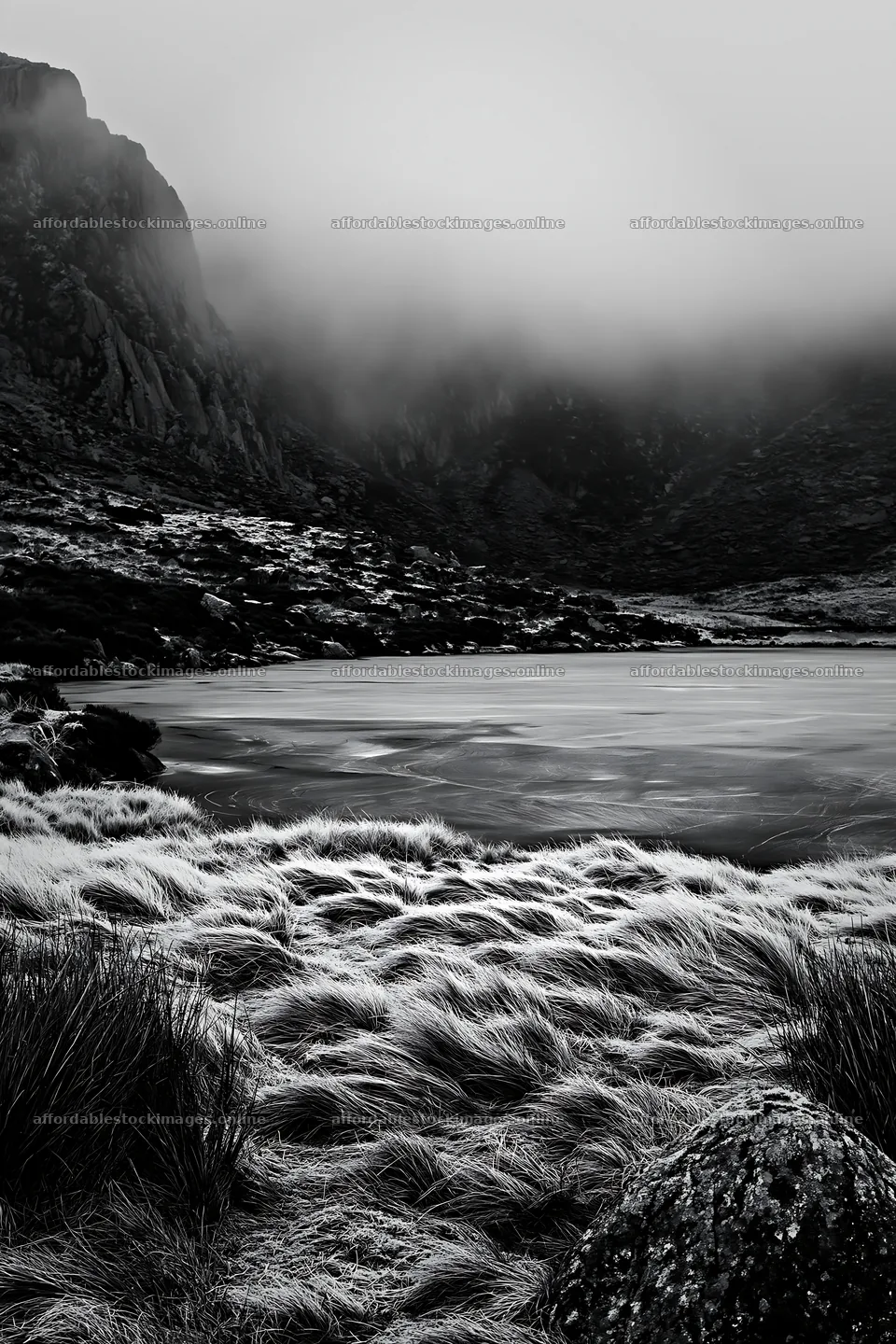 Frozen tarn meadow with fog over the water and rocky landscape – stock images 6480x9722
