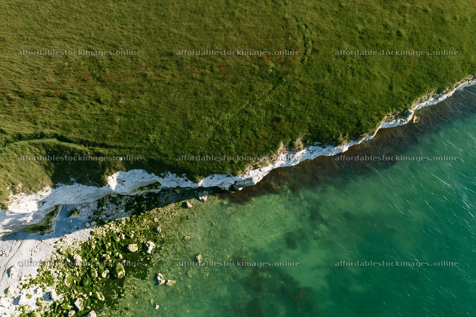 Clifftop meadow overlooking the ocean with rocky shore – stock images 9722x6480
