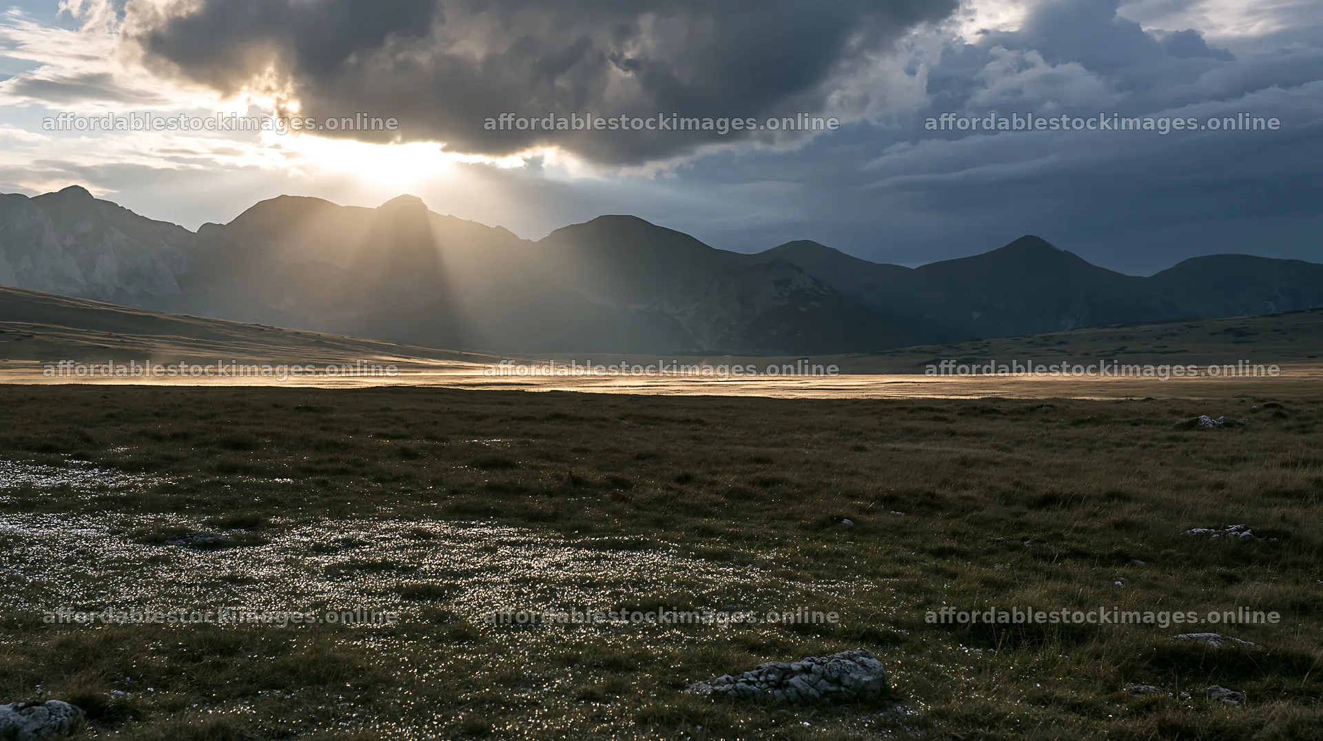 Light rays shine over Bucegi Mountains meadow at sunset – stock images 10608x5938