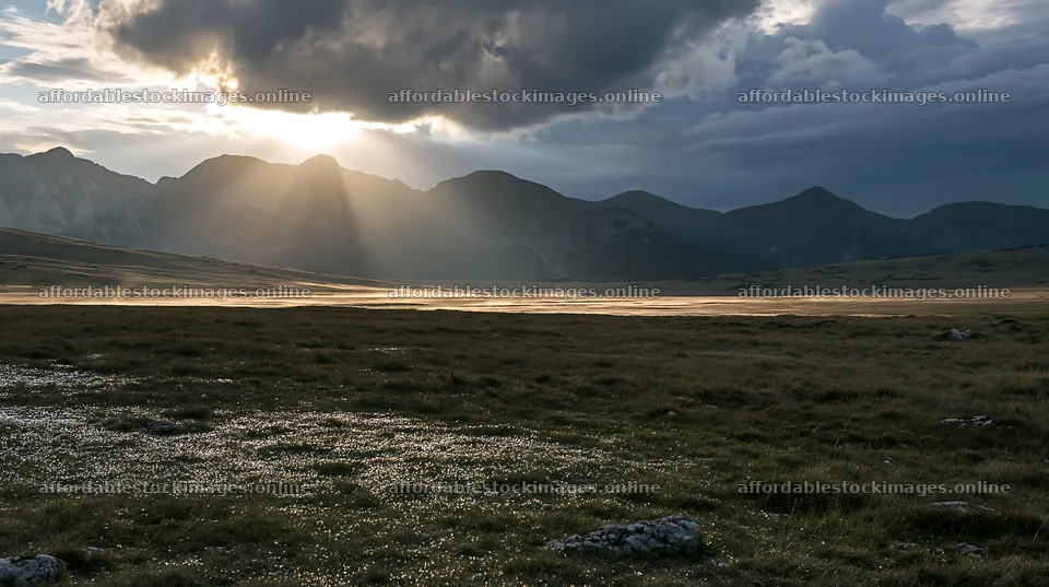 Light rays shine over Bucegi Mountains meadow at sunset – stock images 10608x5938