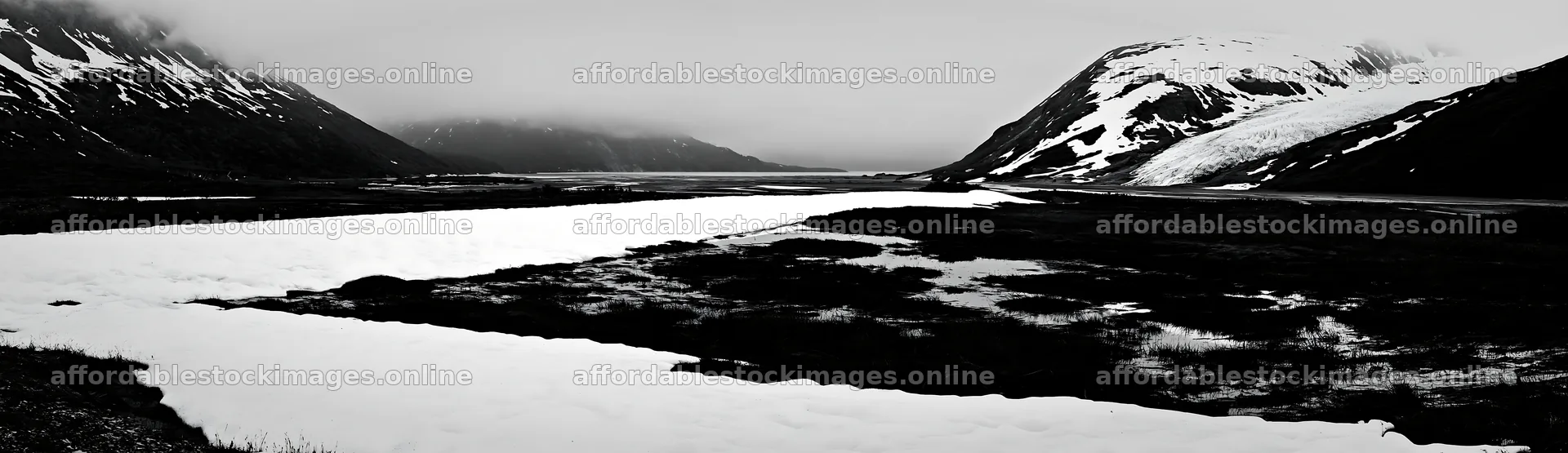 Snowmelt meadow with mountains and cloudy sky in the background – stock images 14762x4268