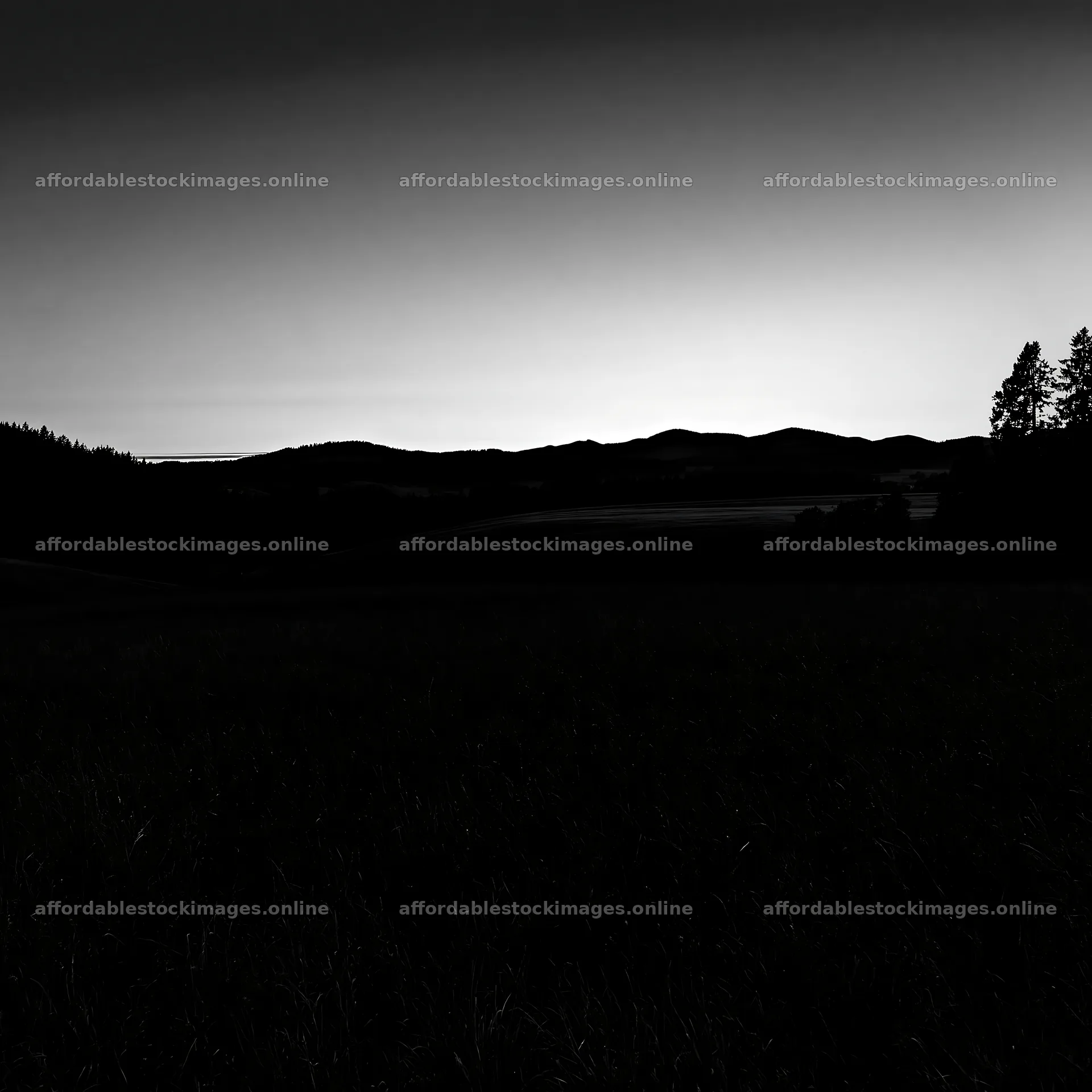 Rolling valley meadows at dusk with distant mountain silhouettes – stock images 7938x7938