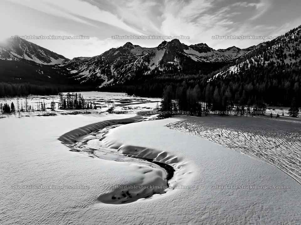 Aerial view of snowy meadow valley surrounded by mountains – stock images 9174x6866